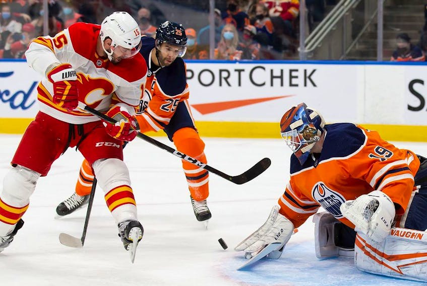 Edmonton Oilers goaltender Mikko Koskinen makes a save against the Calgary Flames’ Brad Richardson at Rogers Place in Edmonton on Saturday, Jan. 22, 2022.