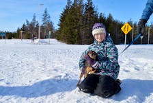 Keira Carruthers holds her dog Charley Jan. 23 at one of the trails open this winter in Cavendish.