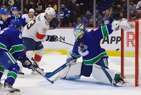 Florida Panthers' Sam Reinhart (13) has his shot deflect off the post behind Vancouver Canucks goalie Spencer Martin and stay out of the goal during the first period of an NHL game in Vancouver on Jan. 21.