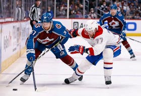 Colorado Avalanche's J.T. Compher (37) and Canadiens' Brett Kulak (77) battle for the puck in the second period at Ball Arena on Saturday, Jan. 22, 2022, in Denver. 