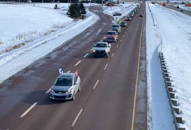 A line of vehicles approaches the Nova Scotia-New Brunswick border on Sunday afternoon as part of a protest against federal government COVID-19 mandates. Several dozen vehicles slowed traffic on the Trans-Canada Highway exiting the province at Fort Lawrence. Darrell Cole – SaltWire Network