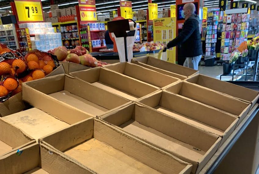 In this file photo, empty shelves at a grocery store in Toronto are pictured on Jan. 22, 2021. 