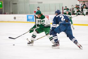 UPEI Panthers defenceman and team captain Owen Headrick looks to protect the puck from St. Francis Xavier X-Men defenceman Bailey Webster of Kelvin Grove during an Atlantic University Sport Men’s Hockey Conference match in Charlottetown earlier this season. Janessa Hogan Photo/UPEI Athletics