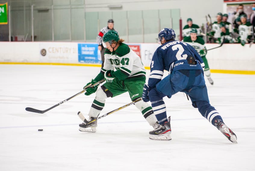 UPEI Panthers defenceman and team captain Owen Headrick looks to protect the puck from St. Francis Xavier X-Men defenceman Bailey Webster of Kelvin Grove during an Atlantic University Sport Men’s Hockey Conference match in Charlottetown earlier this season. Janessa Hogan Photo/UPEI Athletics