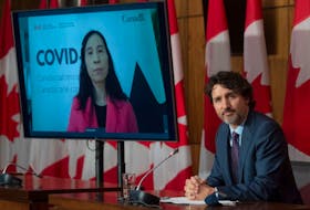 Chief Public Health Officer Theresa Tam, left, appears via video conference as Prime Minister Justin Trudeau attends a news conference in Ottawa in 2021.