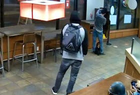 Police have released security video of a person wanted after a man repeatedly stabbed a stranger in the Harbour Centre Tim Hortons on Saturday.