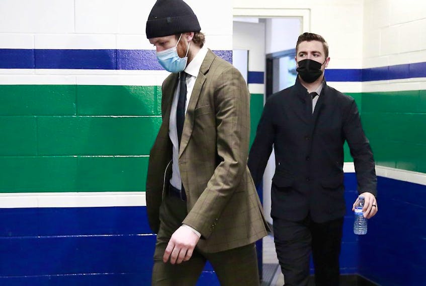 Thatcher Demko #35 (L) and Tanner Pearson #70 of the Vancouver Canucks walk to the Canucks dressing room before their NHL game against the Montreal Canadiens at Rogers Arena on March 10, 2021 in Vancouver.