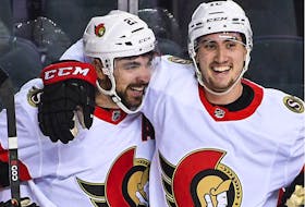Nick Paul, left, celebrates with Alex Formenton after scoring in Calgary on Jan. 13. Each point Paul gets this season will mean more cash for the "Points for Paul" initiative.