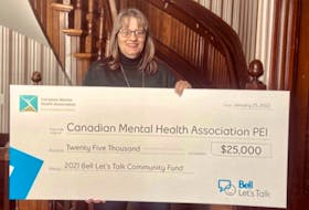 CMHA P.E.I. executive director Shelley Muzika displays a cheque for the $25,000 grant from Bell Let's Talk Community Fund.