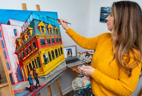 Artist Jan Davison paints in her home studio in Halifax on Tuesday, Jan. 25, 2022.