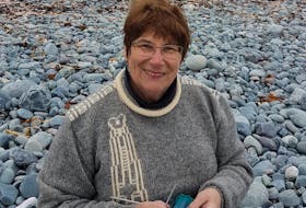 Christine LeGrow knits her design of Blowin 'a Gale trigger mitts.
