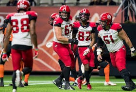 Calgary Stampeders’ Zack Williams (67), Malik Henry (82) and Sean McEwen (51) celebrate Henry’s touchdown against the B.C. Lions at BC Place in Vancouver, on Nov. 12, 2021.