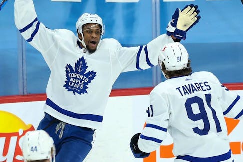 Toronto Maple Leafs forward Wayne Simmonds (left) celebrates with teammate John Tavares after scoring a goal. 
