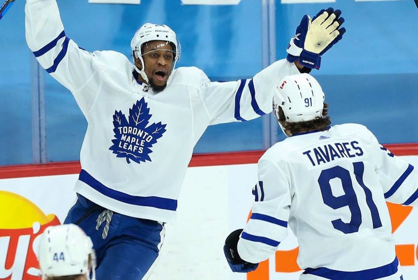 Toronto Maple Leafs forward Wayne Simmonds (left) celebrates with teammate John Tavares after scoring a goal. 

