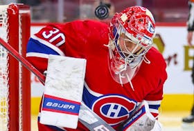 Montreal Canadiens' Cayden Primeau takes a shot off his shoulder during second period against the Philadelphia Flyers in Montreal on Dec. 16, 2021.