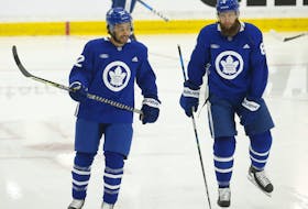 Toronto Maple Leafs' Josh Ho-Sang (left) skates during training camp. 