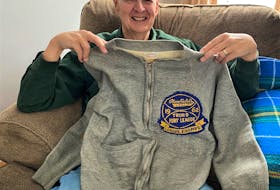 Former Truro Pony Baseball League player Jeff Geddes holds his crested 1962 Stanfields cardigan.