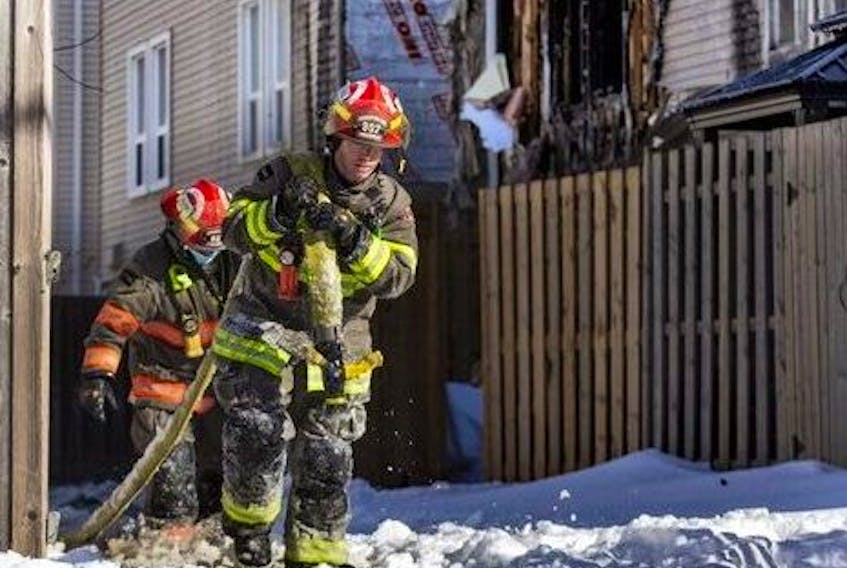 Firefighters at the scene of a triple fatal townhouse fire in Brampton, Ont., on Thursday, Jan. 20, 2022. PHOTO BY ERNEST DOROSZUK /Toronto Sun/Postmedia Network