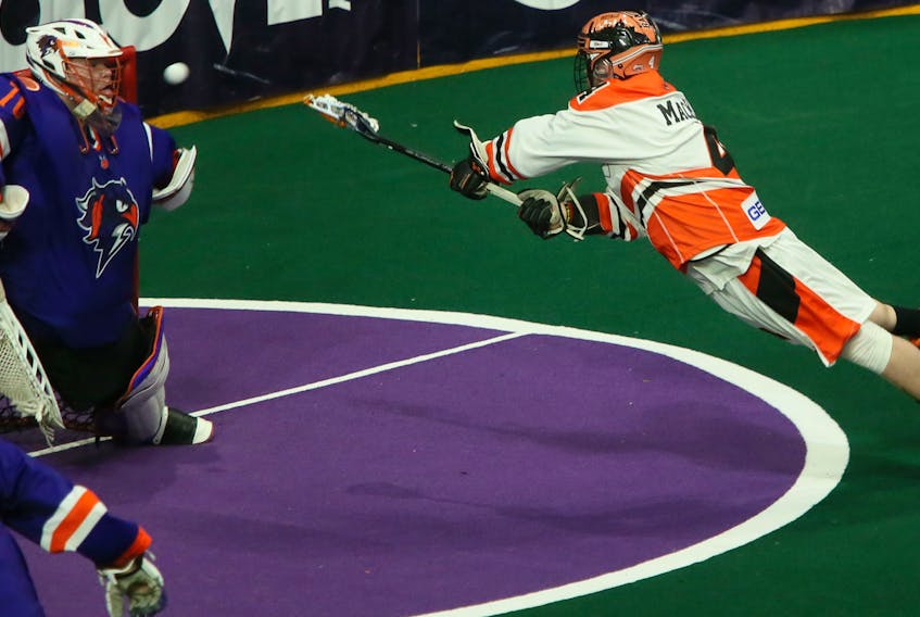 Buffalo Bandits Ian MacKay stretches out on his shot against Halifax Thunderbirds goalie Warren Hill during a National Lacrosse League game in Halifax on March 8, 2020. - Tim Krochak / The Chronicle Herald
