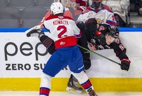 Edmonton Oil Kings' Carter Kowalyk checks Moose Jaw Warriors' Atley  Calvert on Tuesday, Jan. 25, 2022 in Edmonton.