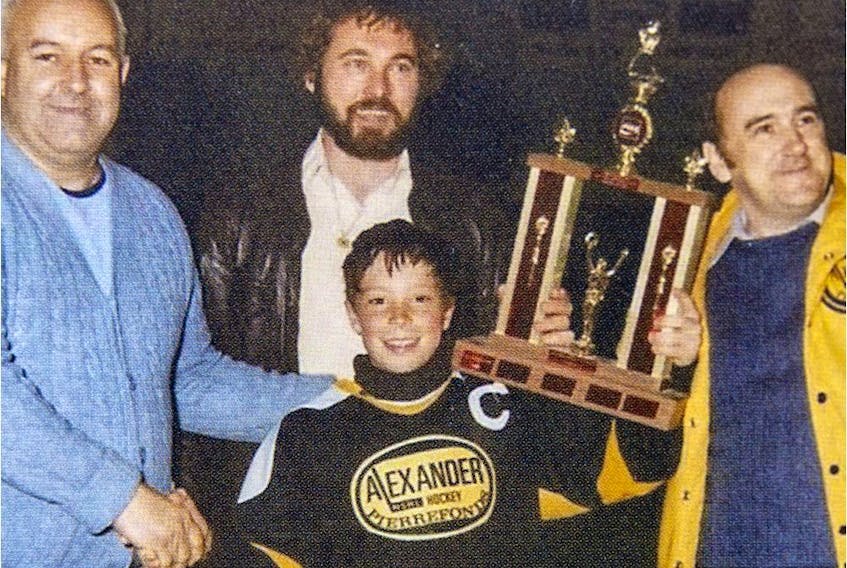 Kent Hughes (centre) accepts the trophy after his Alexander Park team from Pierrefonds won the Dollard-des-Ormeaux novice hockey tournament. Hughes, the Montreal Canadiens new general manager, grew up in the West Island. (Photos courtesy of Emerson Hughes)