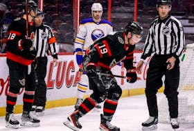 Nova Scotia's Drake Batherson limps off the ice after being injured by Buffalo Sabres goalie Aaron Dell during Tuesday's NHL game in Ottawa.