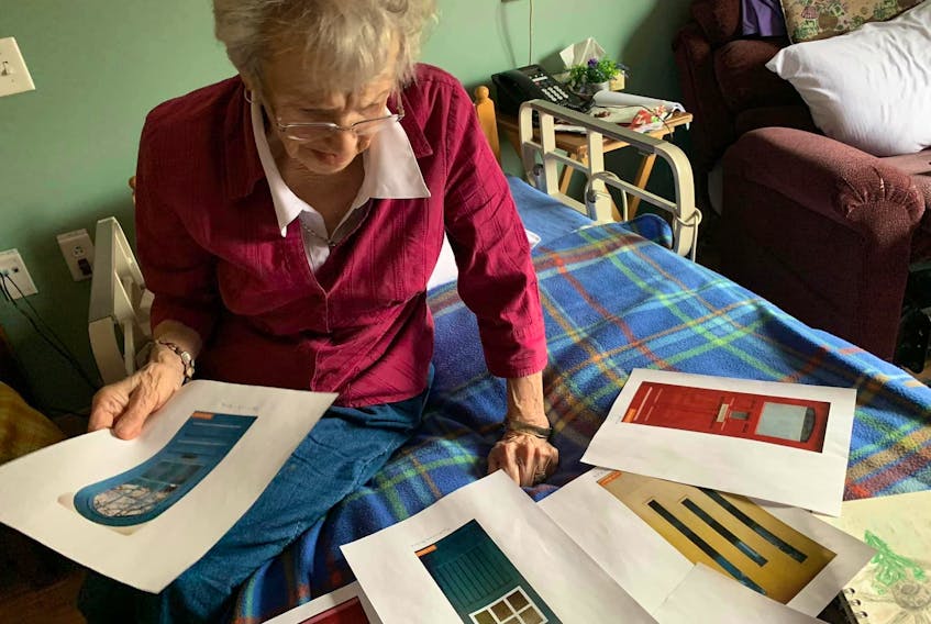A Tideview Terrace resident looks through the selection of real door decals available to install in the seniors long-term care home. TIDEVIEW TERRACE FACEBOOK PAGE