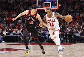 Bulls' DeMar DeRozan drives to the basket against Raptors' fYuta Watanabe during the first half at United Center in Chicago on Wednesday, Jan. 26, 2022. 