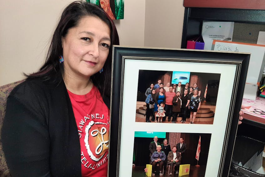 Starr Paul, a Mi'kmaw language instructor at Cape Breton University, holds photos from a 2019 celebration of her mother's 23 year career in the same role at CBU. ARDELLE REYNOLDS/CAPE BRETON UNIVERSITY