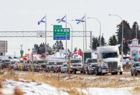 Trucks and other vehicles headed to Ottawa to protest the vaccine mandate drive through Nova Scotia. — Reuters file photo