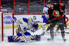 Ottawa Senators right wing Drake Batherson looks on in front of Buffalo Sabres goaltender Aaron Dell (80) as the puck rings off the crossbar during the first period.