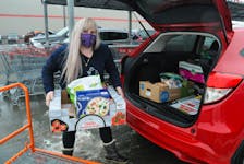 Photo of Bridget Connors, owner/operator of B’s Personal Shoppers & Delivery, loading a customer’s order from Costco at the Shoppes in Galway on Wednesday morning, January 26, 2022. On her personal business card handout it states, “At B’s Personal Shoppers & Delivery, we cater to the busy professional, the elderly, and everyone in between . . . . .providing professional and speedy service to help ease the tension of daily errands.” Connors serves the St. John’s and surrounding areas.
-Joe Gibbons/The Telegram  
