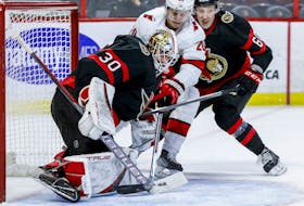 Senators goaltender Matt Murray (30) stops Carolina Hurricanes center Sebastian Aho (20) as Ottawa Senators defenceman Lassi Thomson (60) checks during second period on Thursday night. 
