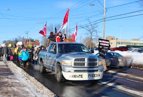 Protesters march down University Avenue in Charlottetown on Jan. 22 as part of a rally against COVID-19 public health measures. Chelsea Perry • Special to The Guardian