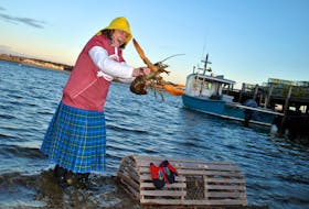 Lucy the Lobster spreads her claws as Donna Hatt helps her up on her weather predicting perch on the North East Point waterfront for her third Groundhog Day prediction in 2020. KATHY JOHNSON PHOTO