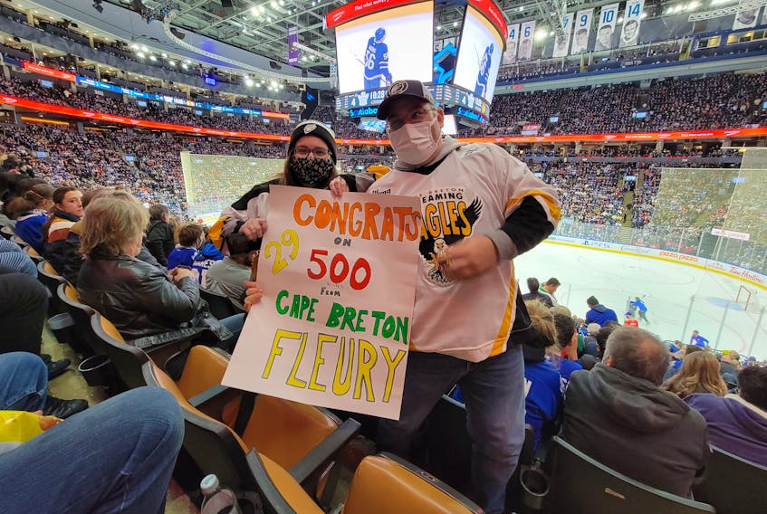 Andy Burke, right, and Samantha MacKinnon of River Bourgeois, Richmond County hold a sign congratulating former Cape Breton Eagle goaltender Marc-Andre Fleury of the Chicago Blackhawks for reaching the 500-win plateau. The two attended the Blackhawks and Toronto Maple Leafs game at Scotiabank Arena in Toronto on Dec. 11, two days after Fleury posted his 500th win against the Montreal Canadiens on Dec. 9 in Montreal. Unfortunately, Fleury didn’t play against the Maple Leafs, but the couple still showed their support for MacKinnon’s favourite Eagle. CONTRIBUTED • ANDY BURKE