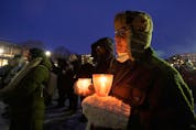People take part in a vigil on Saturday, Jan. 29, 2022, in Montreal to mark the fifth anniversary of a mosque shooting in Quebec City that left six people dead.