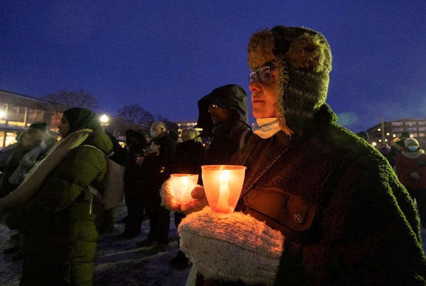 People take part in a vigil on Saturday, Jan. 29, 2022, in Montreal to mark the fifth anniversary of a mosque shooting in Quebec City that left six people dead.