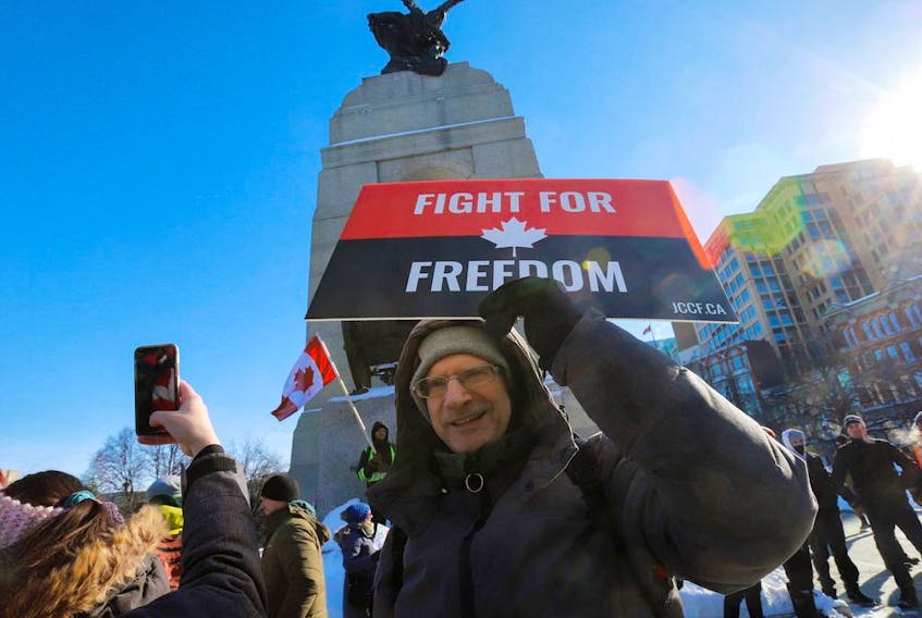  An unidentified man poses for a photo in front of the National War Memorial on Saturday.