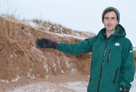 Garrett Mombourquette, acting conservation resources manager with Parks Canada in P.E.I., shows SaltWire Network on Jan. 28 the amount of dune at Brackley Beach that was sheered off from two winter storms in early January.