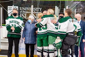 Sisters Ally, 19, and Kelly Clements, 9, congratulate Donnie MacFadyen on his 21 years of involvement with the UPEI women’s hockey program. UPEI raised a banner at MacLauchlan Arena in honour of MacFadyen’s contributions on Nov. 28. MacFadyen founded the program in 2001 and has served in many capacities, including coaching, management, administration and assisting players with their education. Janessa Hogan Photo/UPEI Athletics