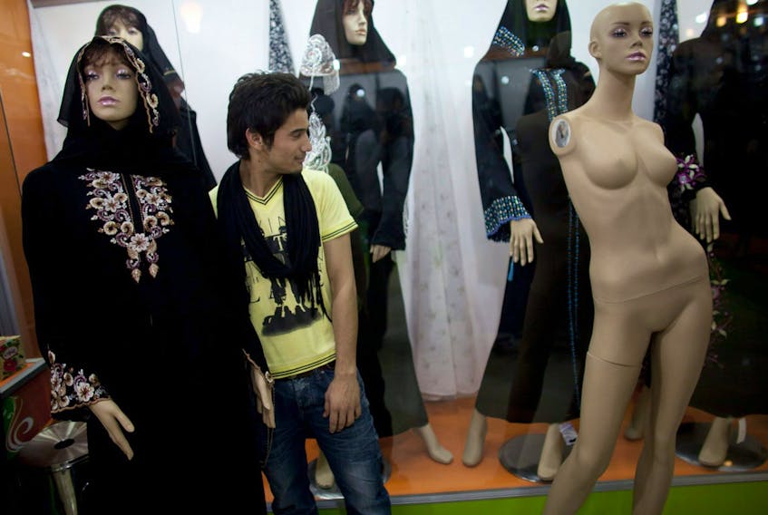Women's clothes are displayed on mannequins as a man shops in a new market on Nov. 1, 2010 in Herat, Afghanistan. 