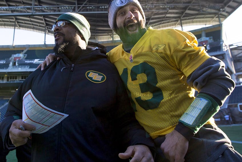 Then-Edmonton Elks quarterback Mike Reilly (13) grabs offensive co-ordinator Stephen McAdoo for a picture, which the coach does not like to have taken, during practice on Nov. 28, 2015, ahead of the 103rd Grey Cup in Winnipeg.