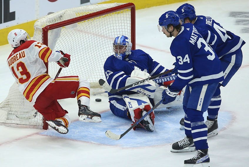 Johnny Gaudreau buries the puck behind  Toronto Maple Leafs goaltender David Rittich in overtime in Toronto on April 13, 2021. 