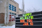  A sign outside Mount View School announces the postponement of return to classes on Monday, Jan. 3, 2022.