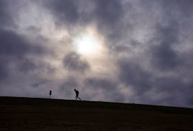 A pedestrian trudges up Citadel Hill as the sun tries to poke through the clouds on Wednesday, Jan. 5, 2022.