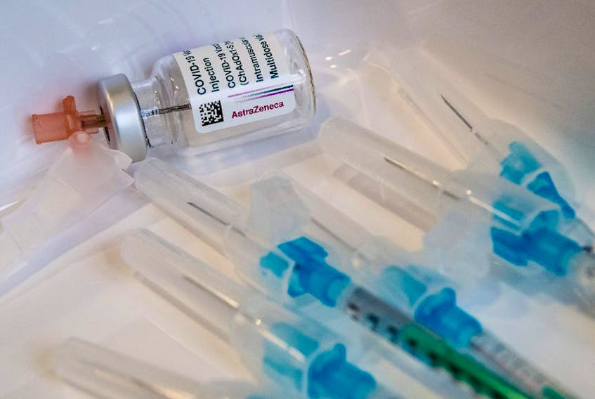  An empty vial of the AstraZeneca COVID-19 vaccine and some syringes are seen on a tray at the university hospital in Halle/Saale, eastern Germany.