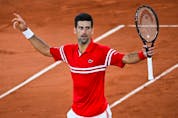  Serbia’s Novak Djokovic celebrates after winning against Spain’s Rafael Nadal at the end of their men’s singles semi-final at the 2021 French Open in Paris on June 11, 2021.
