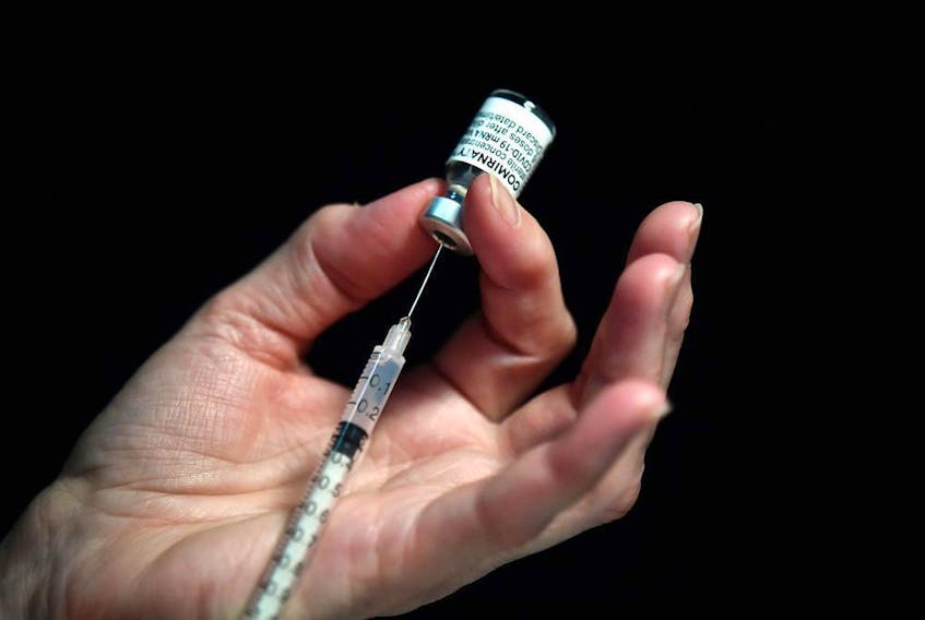  A file photo shows a nurse preparing a syringe of the Pfizer-BioNtech Covid-19 vaccine.