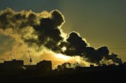 The sun starts to set behind exhaust from two chimneys near the University Hospital as cold temperatures still persist in Edmonton, December 30, 2021. The shapes in the exhaust reminds one of the Rorschach ink blot test. Ed Kaiser/Postmedia